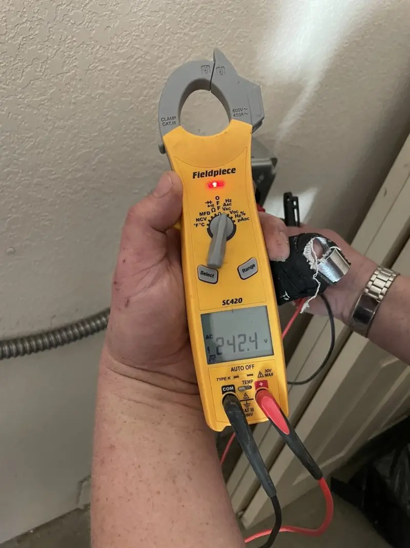 Voltage testing with clamp meter during Whole House Surge Protector in Newport